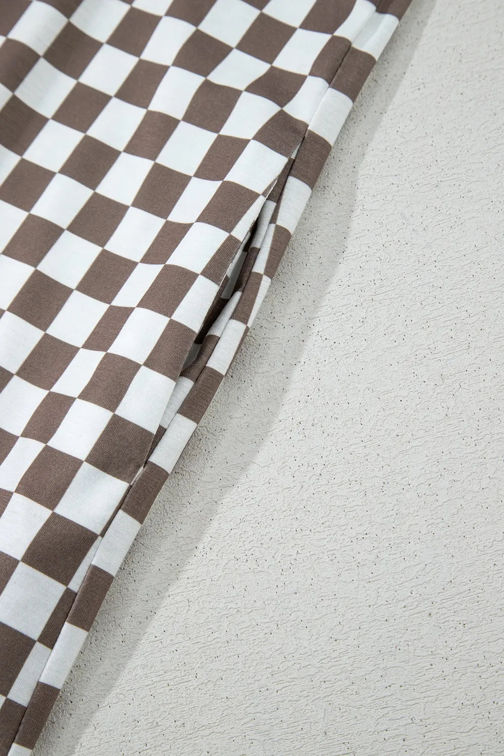 Brown-and-white checkered wide-leg jumpsuit fabric and side seam detail