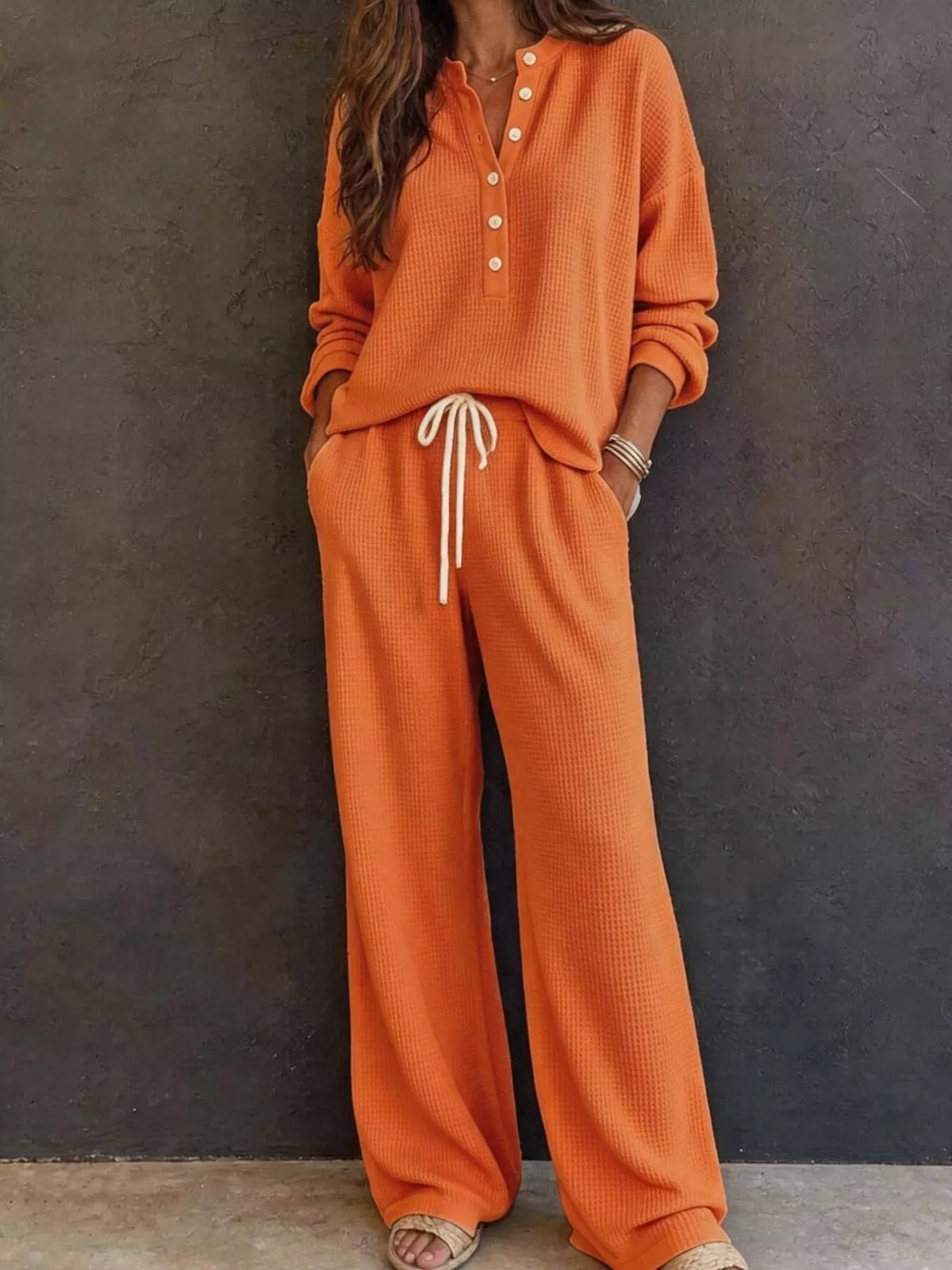 Waffle knit lounge set in orange: henley pullover with button placket and wide-leg drawstring pants