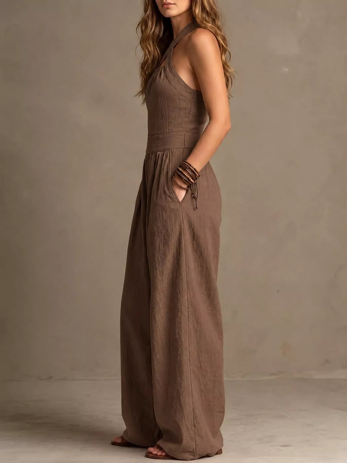 Brown halter linen jumpsuit with high waist and wide-leg wide drape