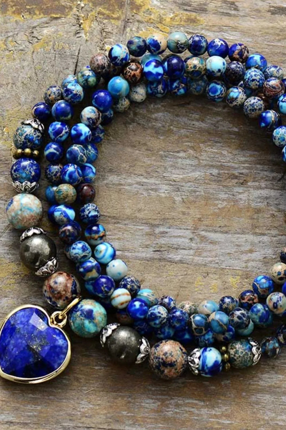 Three-layer bracelet with royal blue bead strands and blue heart pendant