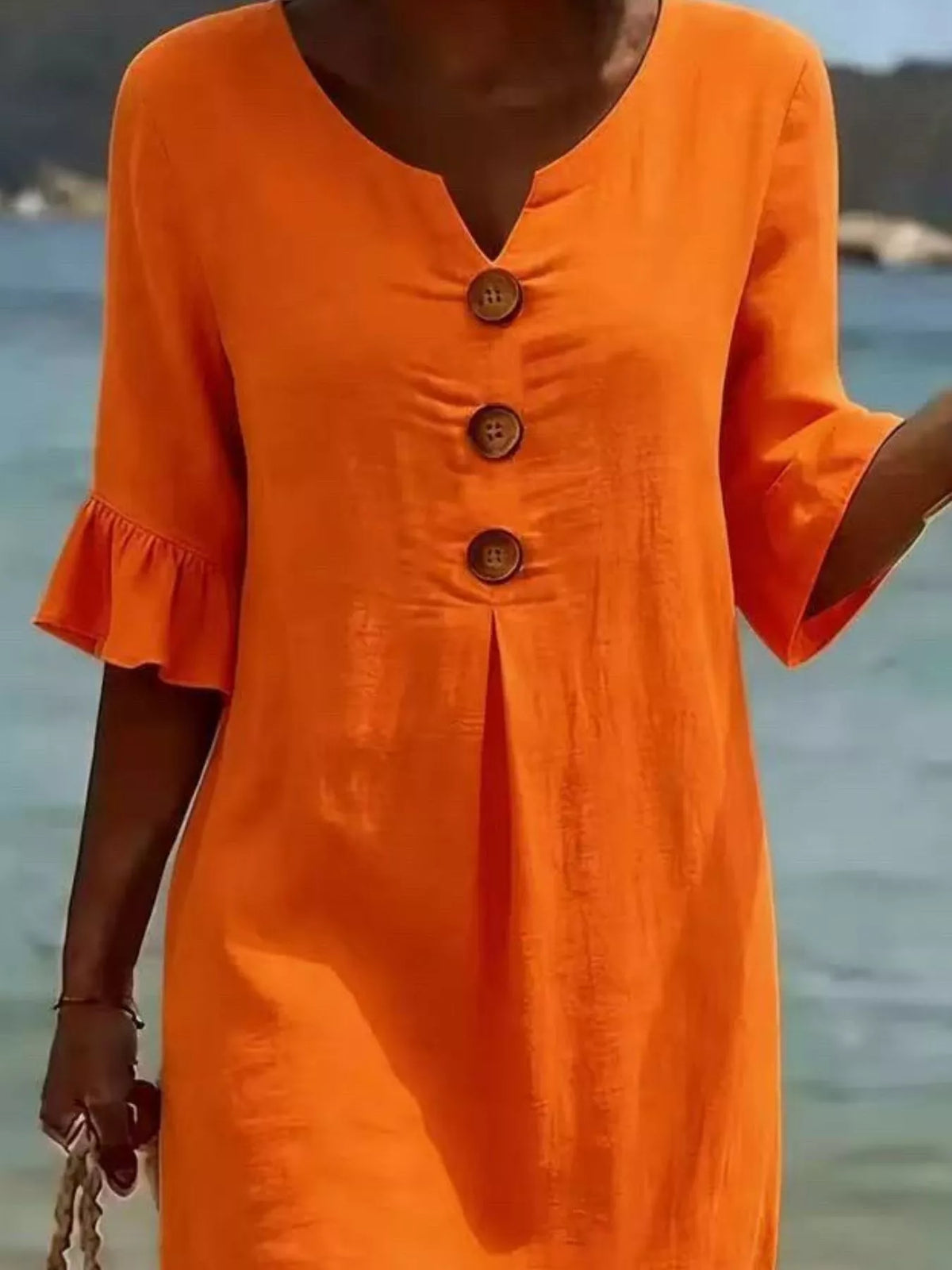 Orange button-front ruffle half-sleeve dress with V-neck and three brown buttons