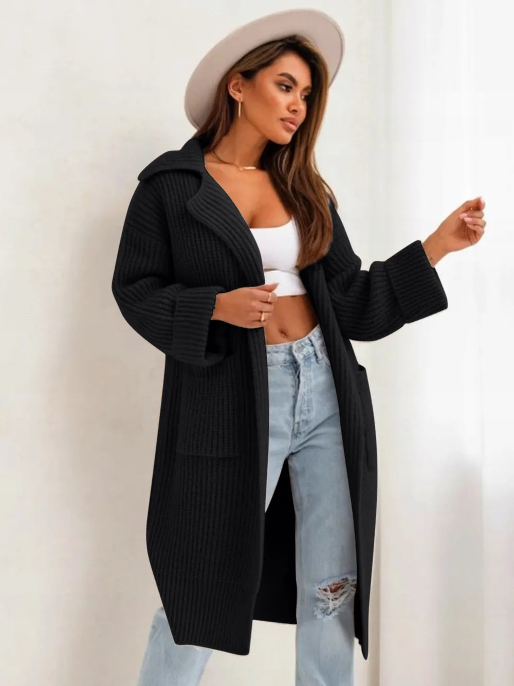 Black cardigan sweater with collared neck, dropped shoulders, and side pockets, open front