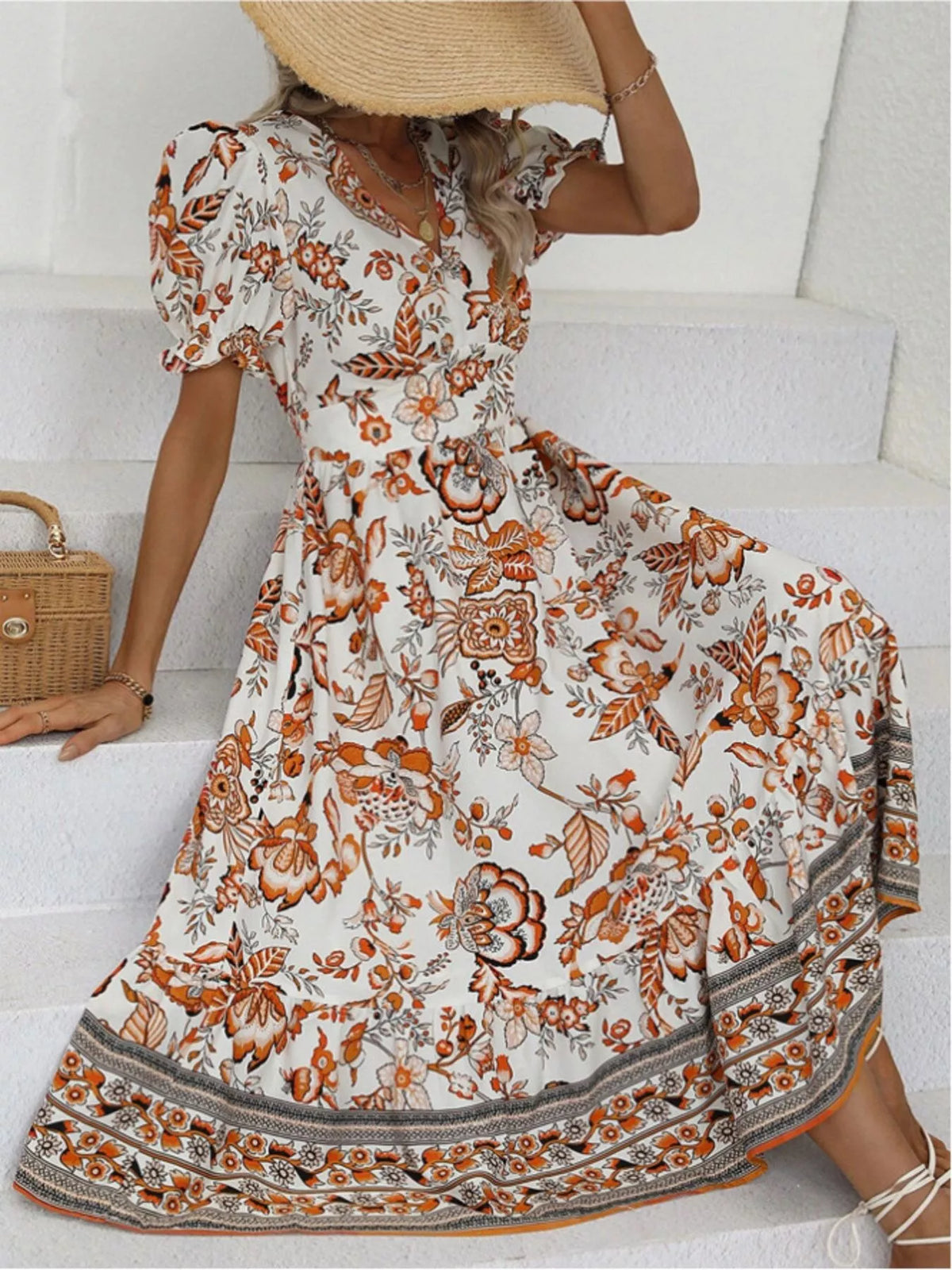 Floral print midi dress with puff sleeves and V-neck, orange-and-cream border detail