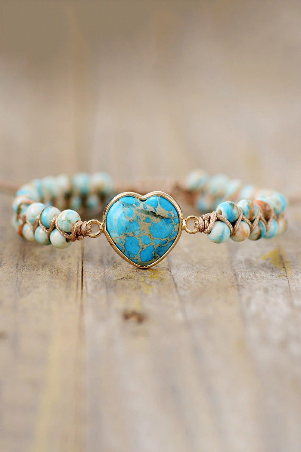 Turquoise beaded heart bracelet with gold-tone heart pendant and adjustable ties