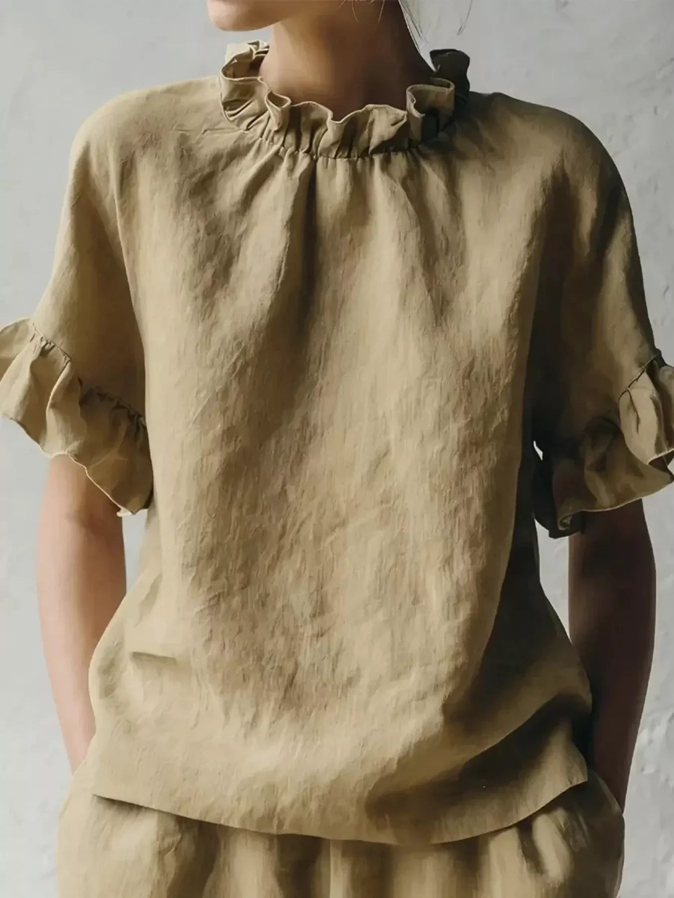 Beige ruffled-neck half-sleeve blouse with gathered collar and tiered hem