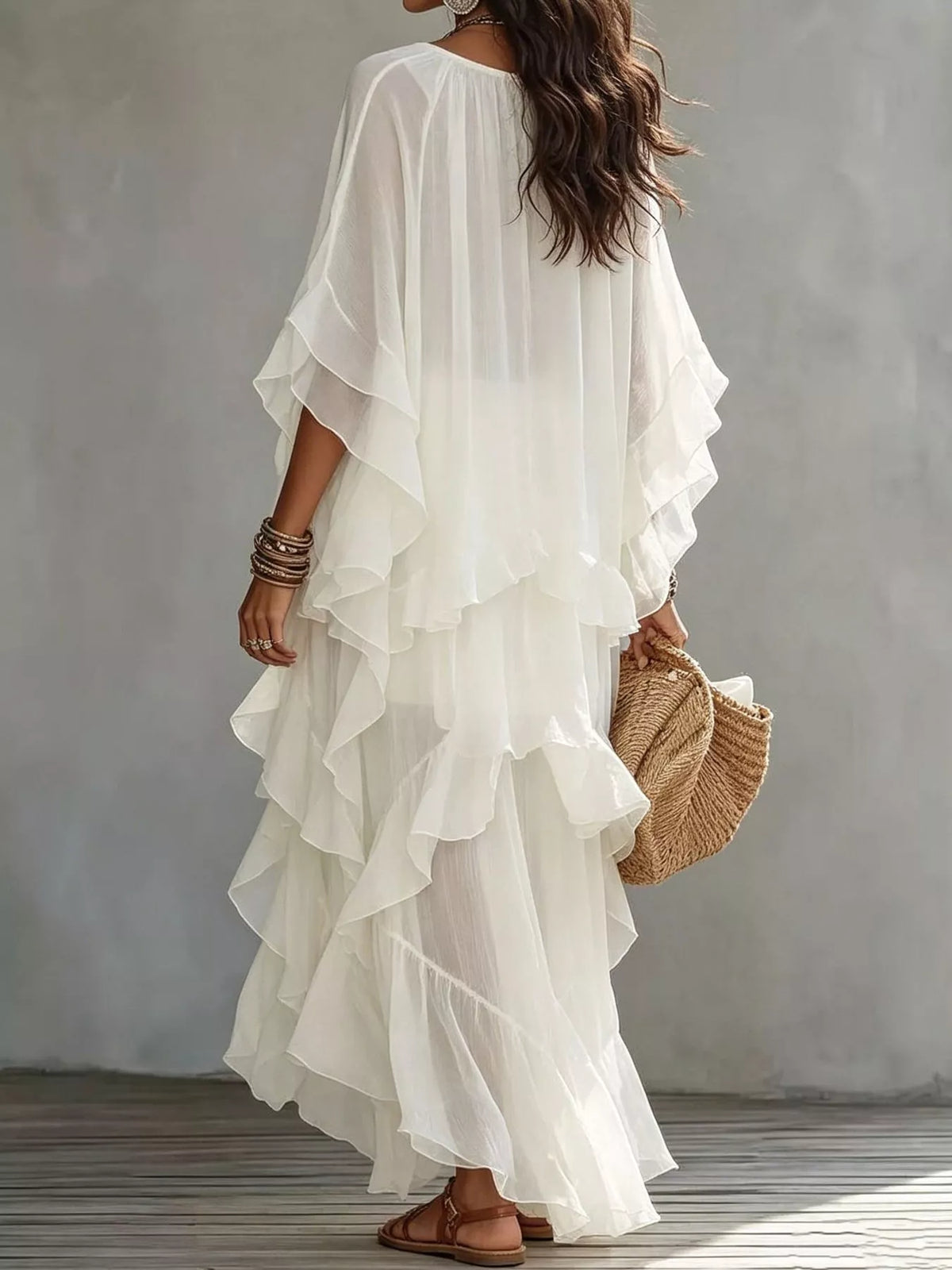 White tiered maxi dress with ruffled layers and loose draped sleeves