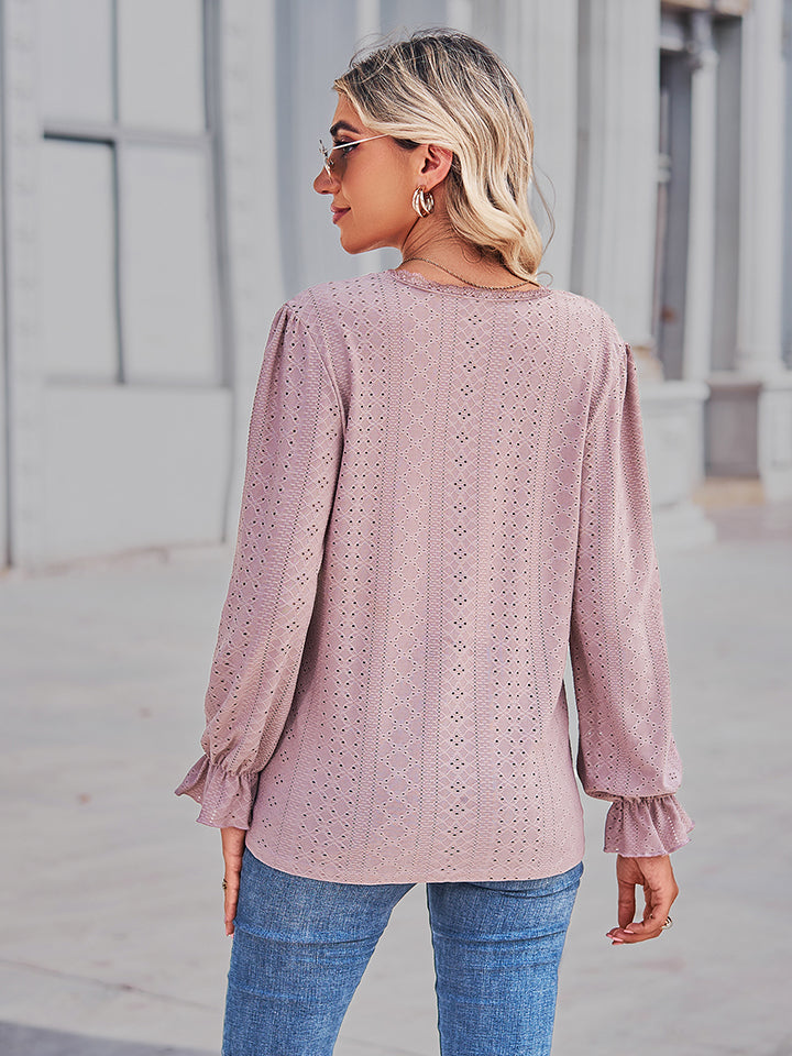 Blush pink eyelet V-neck blouse from back view with gathered flounce sleeve cuffs