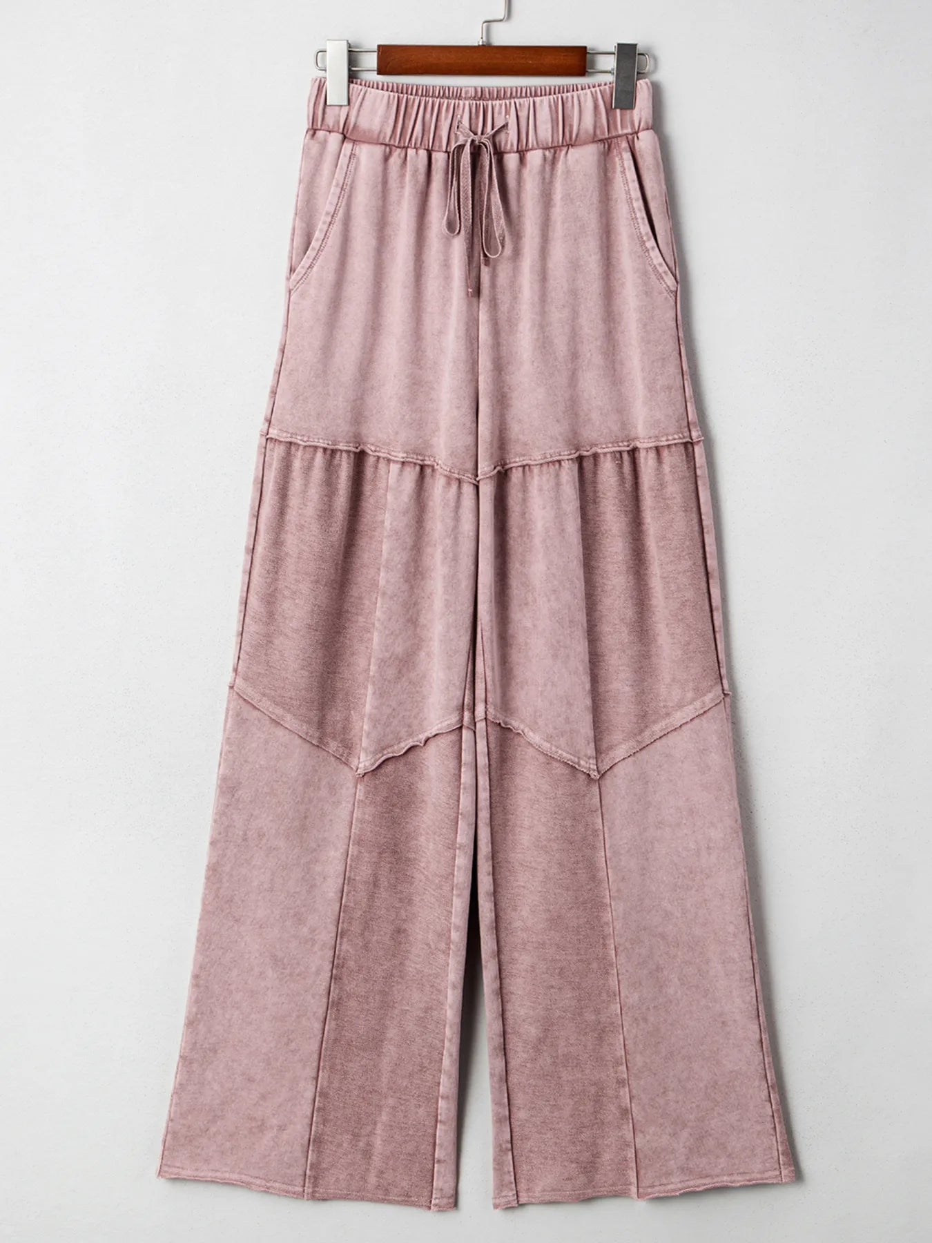 Dusty pink tiered wide-leg pants on hanger, gathered elastic waist with drawstring