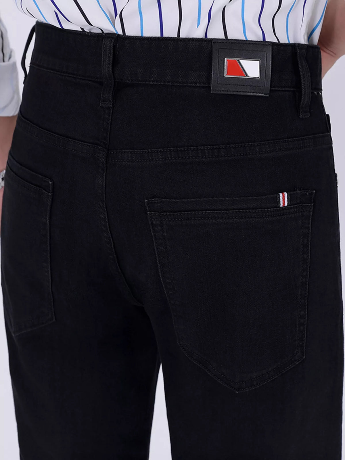 Black slim-fit jeans with logo label patch and front pocket stitching