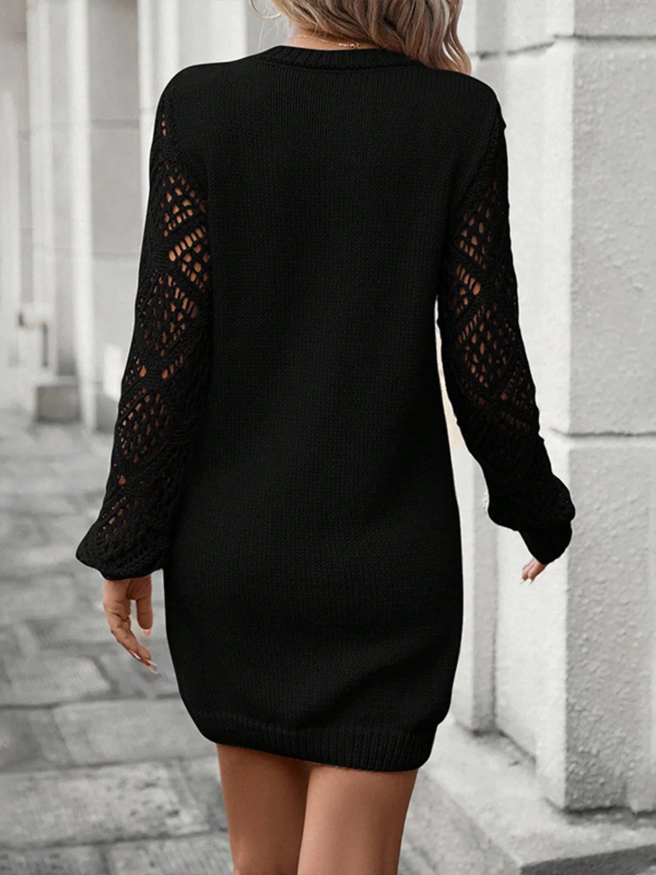 Black knit sweater dress, back view, hollow-out sleeve panels
