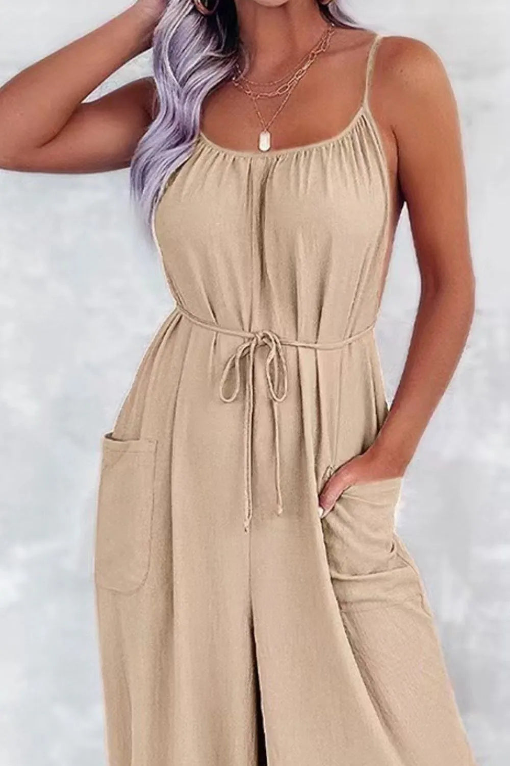 Tan spaghetti-strap wide-leg jumpsuit with drawstring waist and front pocket