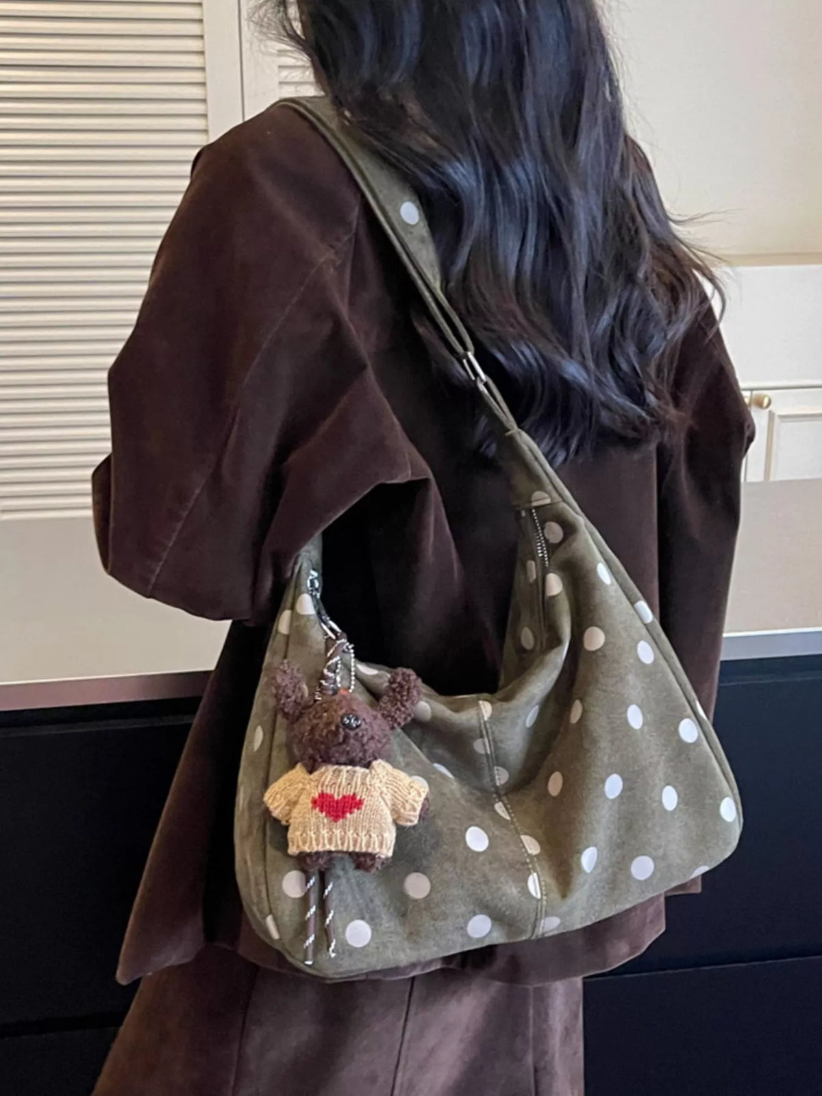 Green suede polka-dot shoulder bag with embroidered teddy charm and adjustable strap