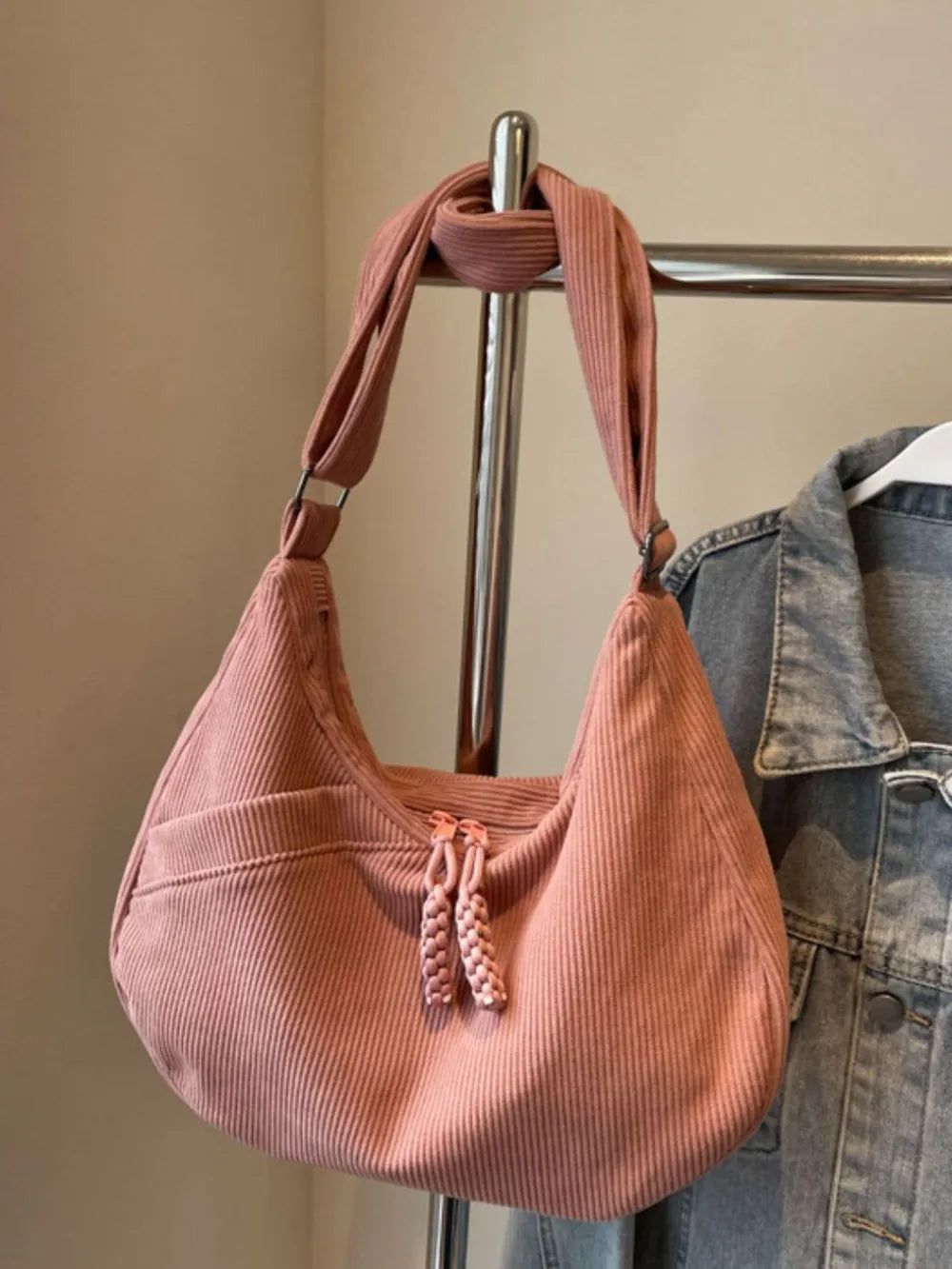 Dusty pink ribbed shoulder bag with adjustable strap and drawstring top