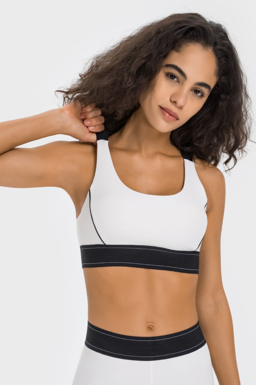 White contrast sports bra with black trim band and racerback straps