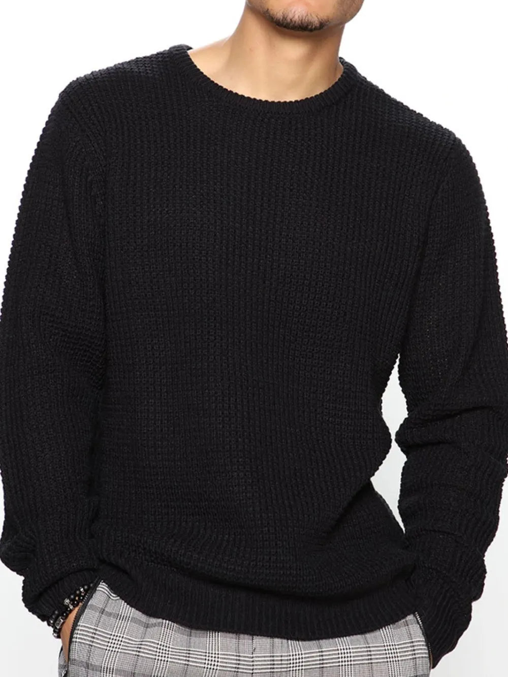 Black textured knit crewneck sweater with long sleeves and ribbed cuffs