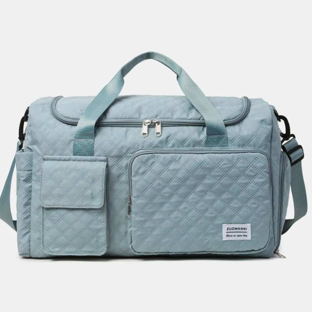 Light blue duffel travel bag with front zip pocket, padded handles, and side straps