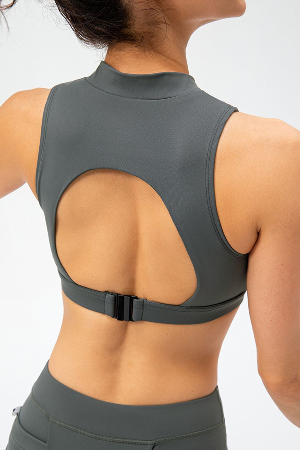 Dark gray active tank top with cutout back, front half-zip, sleeveless cropped fit