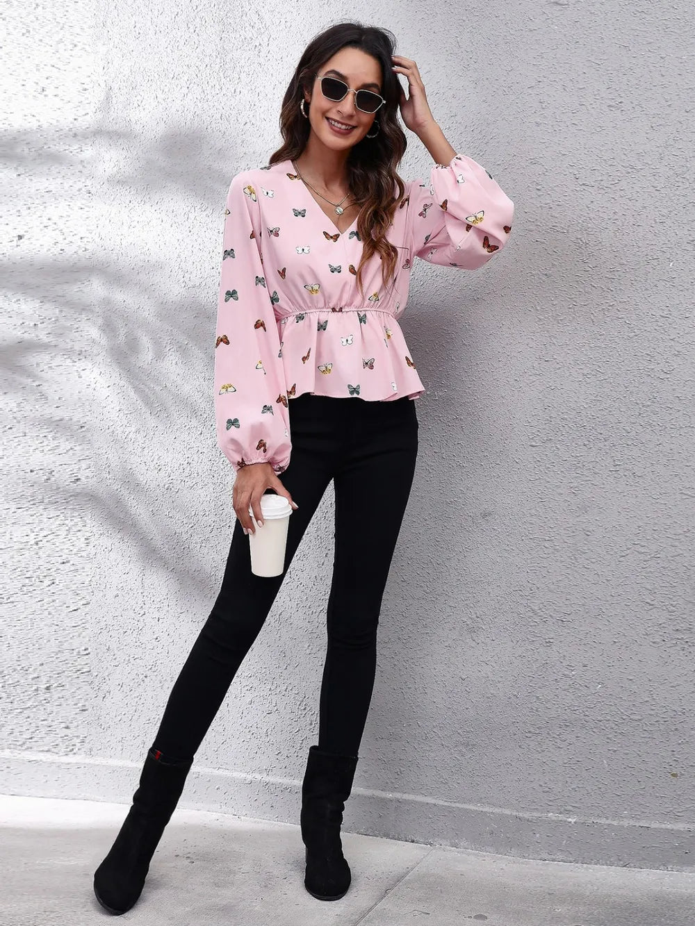 Blush pink butterfly print peplum blouse with V-neck and balloon sleeves