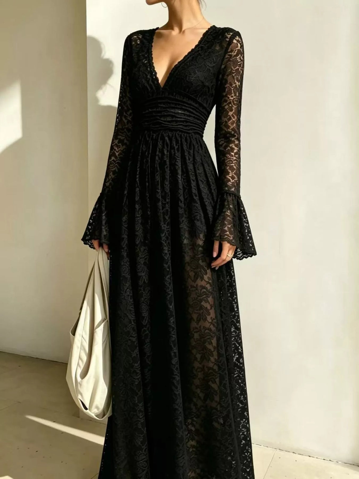 Black textured lace maxi dress with gathered waist and long flared sleeves, V-neck.
