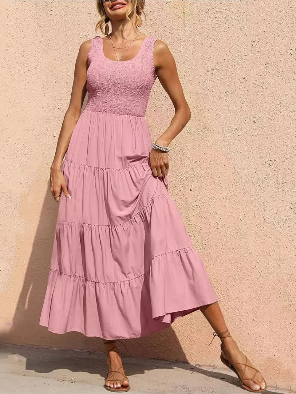Tiered smocked wide strap dress in blush pink with tiered ruffle skirt.