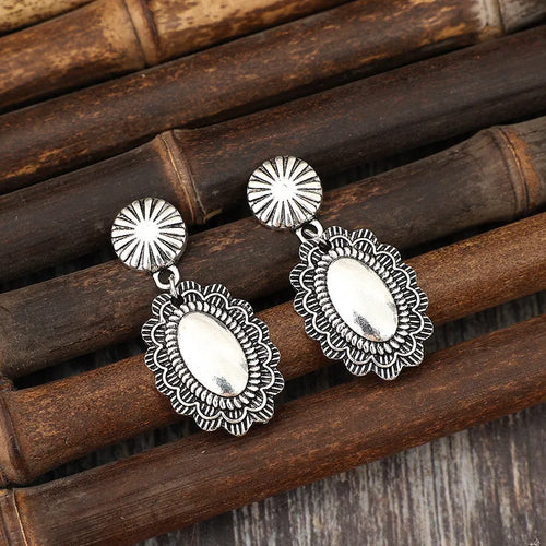 Silver flower dangle earrings with oval center medallions and scalloped filigree