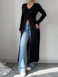 Longline V-neck button-front cardigan in black with long sleeves and side opening