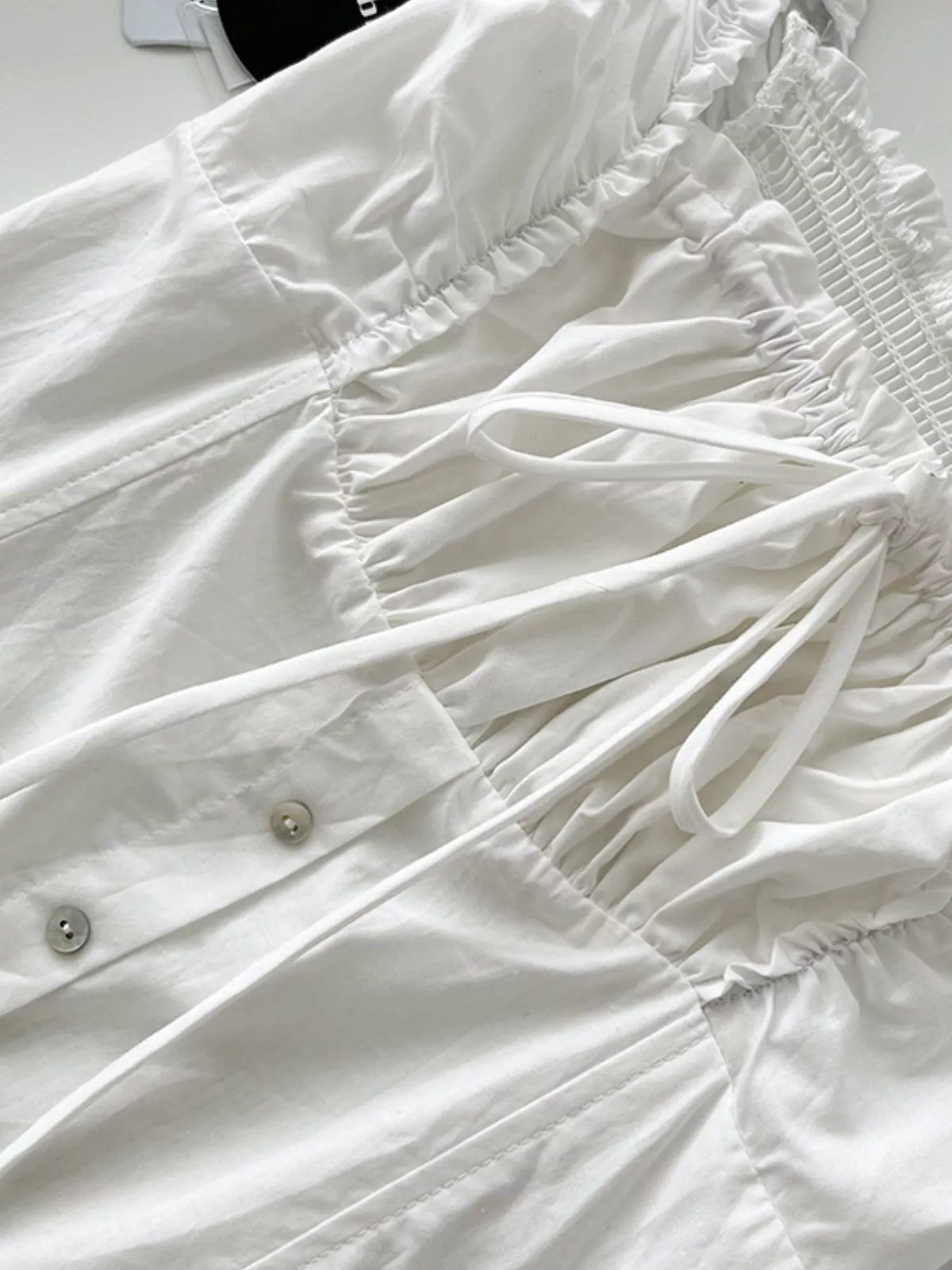 White ruffled square-neck tiered cotton maxi dress, gathered bodice close-up