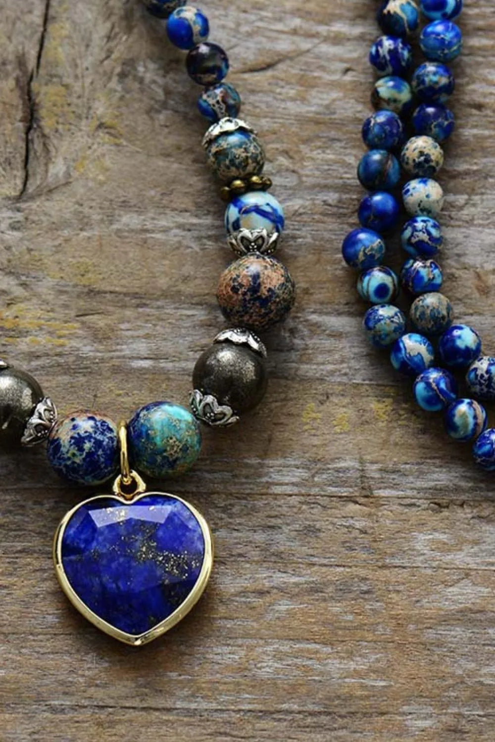 Blue bead bracelet with heart pendant on a three-strand layout
