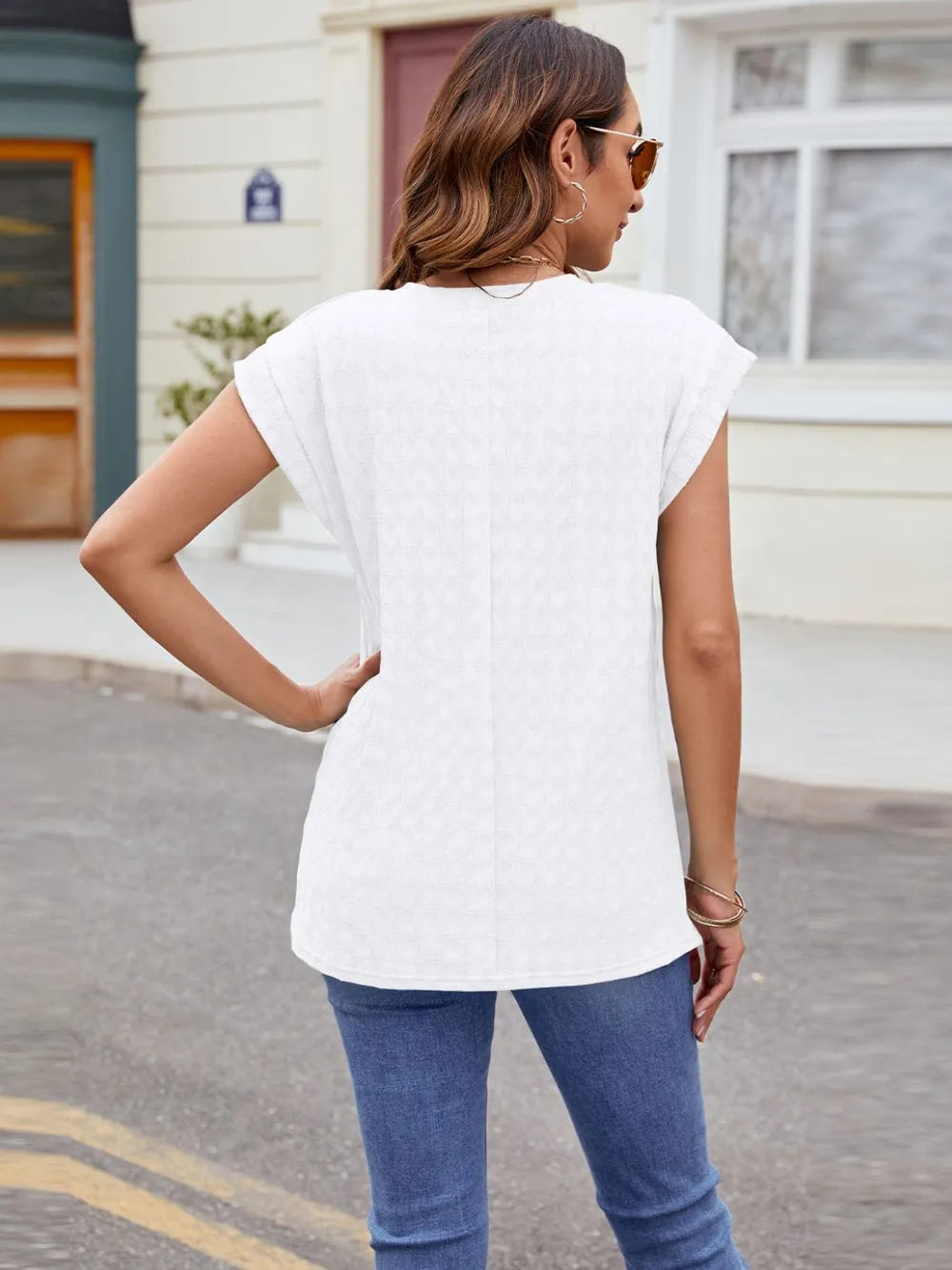 Textured round neck cap-sleeve T-shirt in white, back view with short cap sleeves.