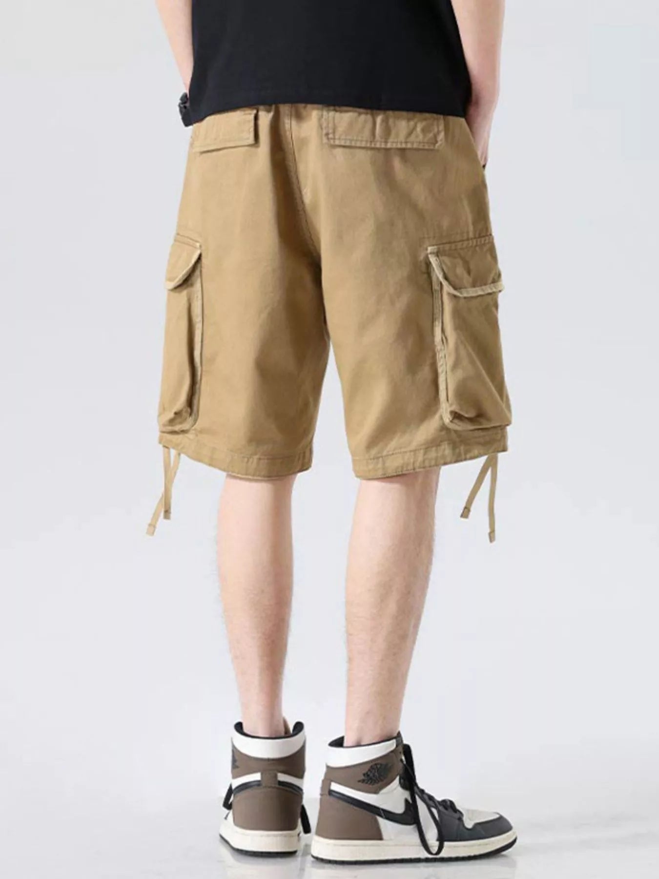 Khaki cargo shorts with cargo pockets, drawstring hem ties, relaxed wide-leg fit
