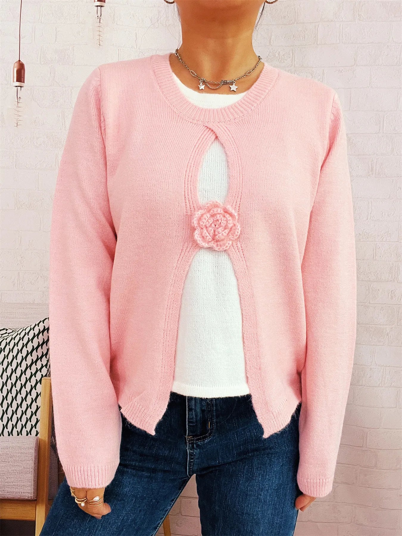 Pink round-neck sweater with white contrast keyhole panel and flower appliqué
