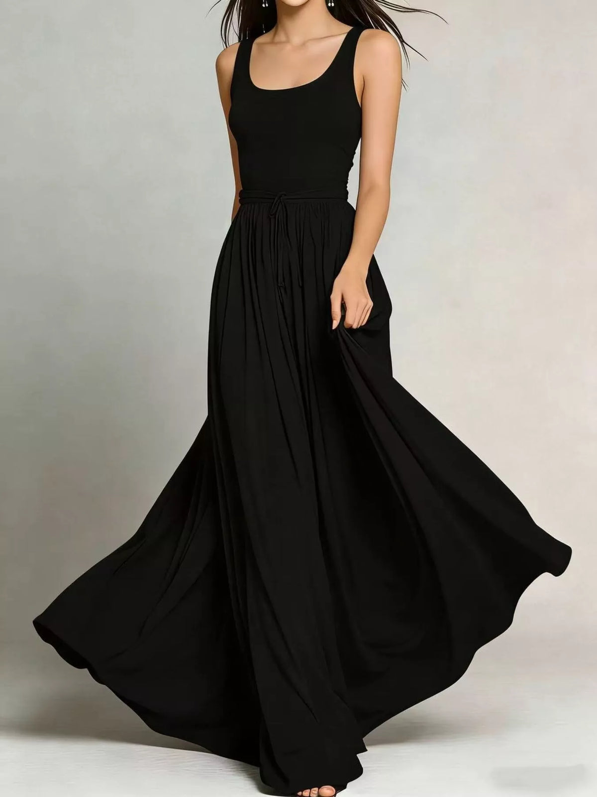 Black sleeveless maxi dress with gathered drawstring waist and flowing skirt
