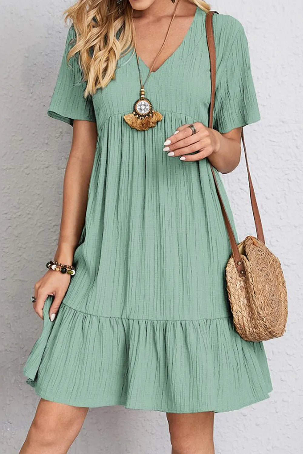 Green V-neck short-sleeve dress with gathered bodice and tiered ruffle hem