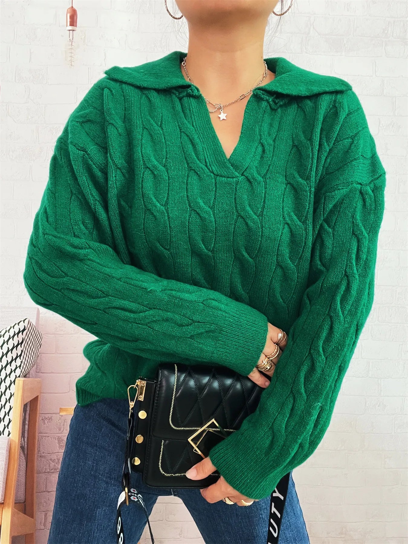 Green cable-knit johnny-collar sweater with long sleeves, cable texture and V neckline.