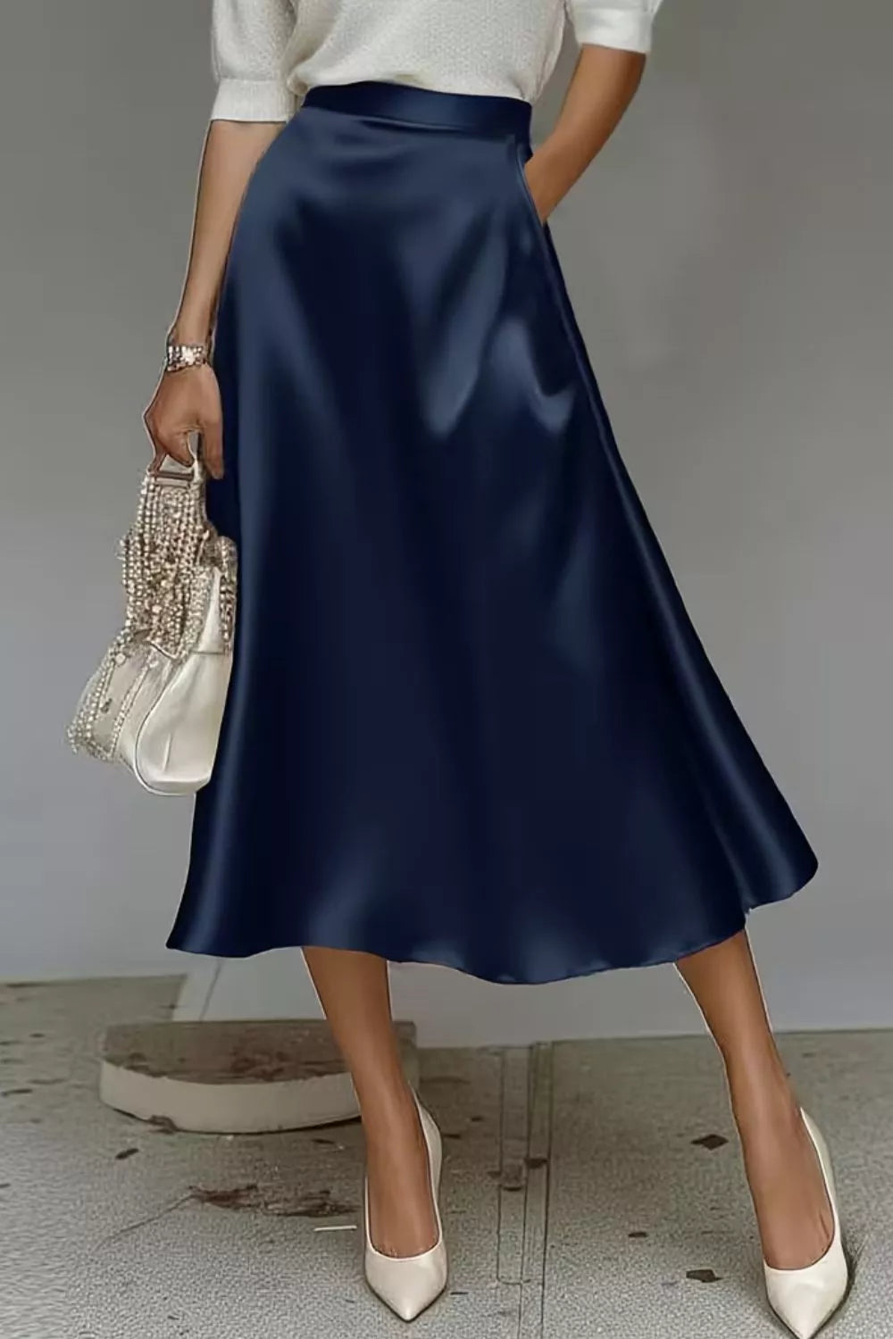 Satin A-line midi skirt in navy with full A-line flare and side pockets