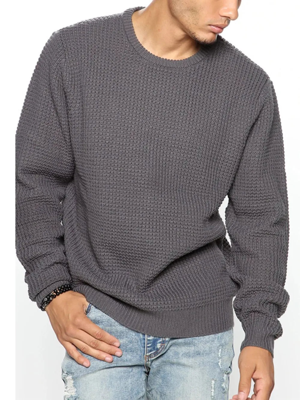 Dark gray textured knit crewneck sweater with long sleeves and ribbed cuffs