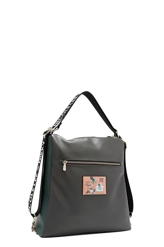 Dark green backpack with front patch, gold zipper, and patterned side strap