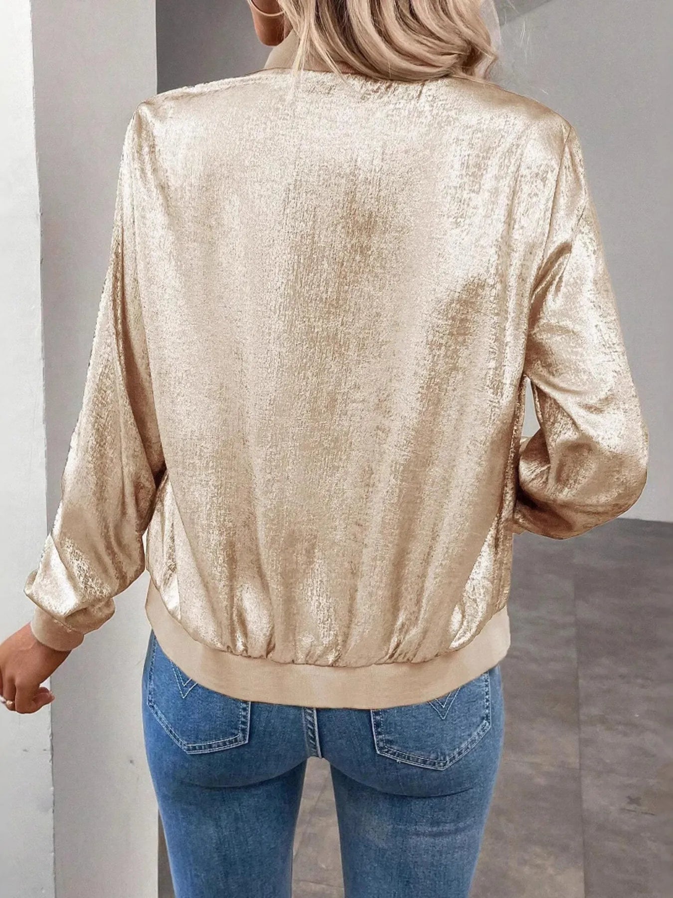 Back view of gold zip-up long sleeve jacket with ribbed hem and cuffs