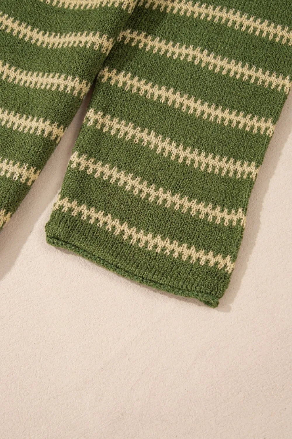 Moss green sweater hem with ribbed cuff and cream horizontal stripe knit