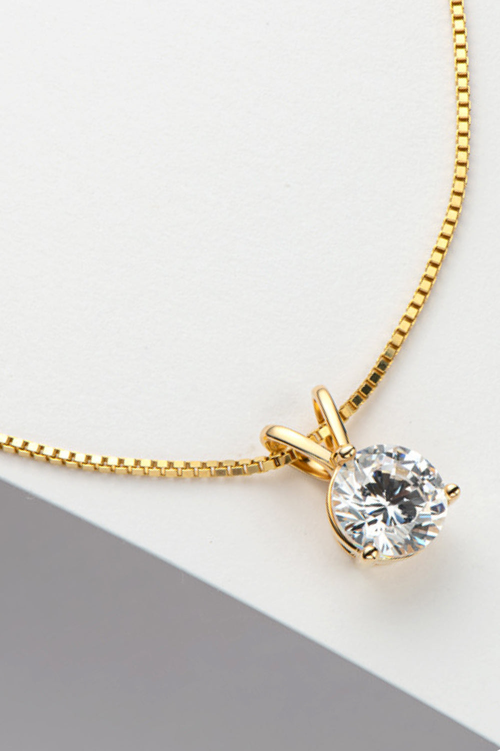 Gold-tone pendant necklace with round moissanite stone and link chain