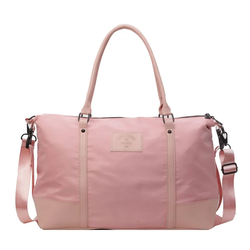 Pink polyester travel duffel bag with detachable crossbody strap and top handles