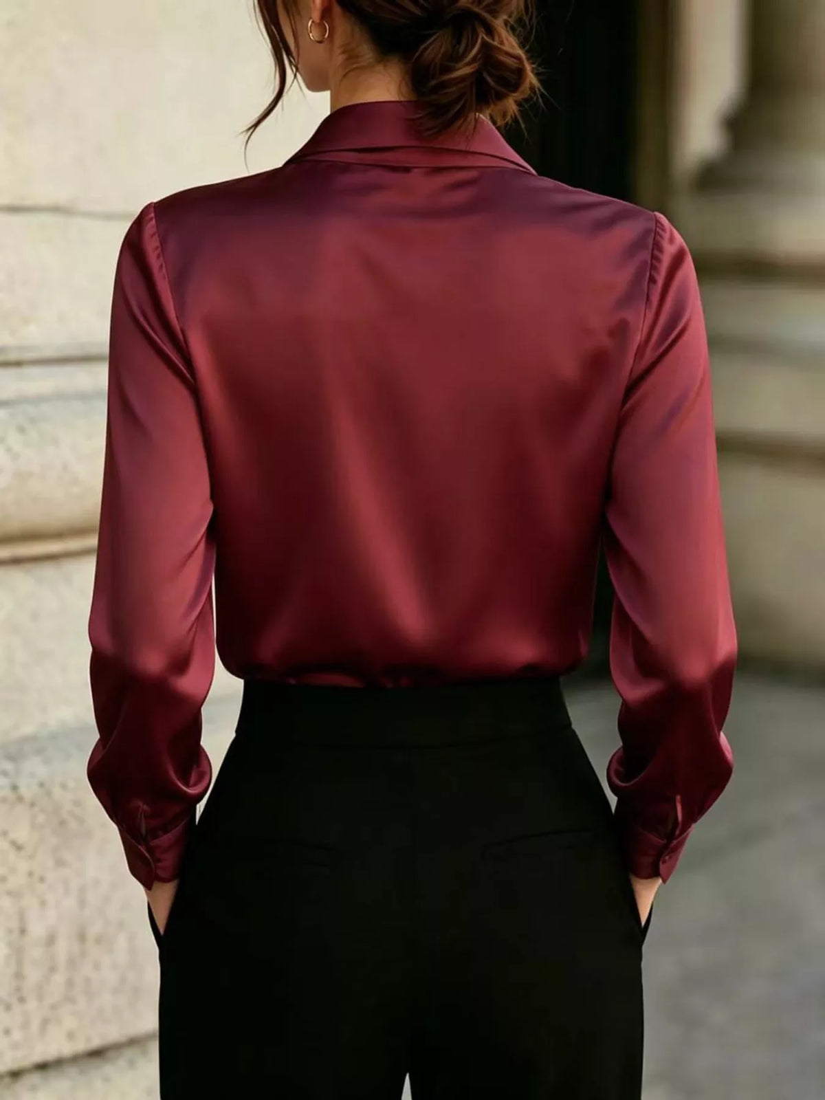 Burgundy satin blouse back view with long sleeves and smooth drape