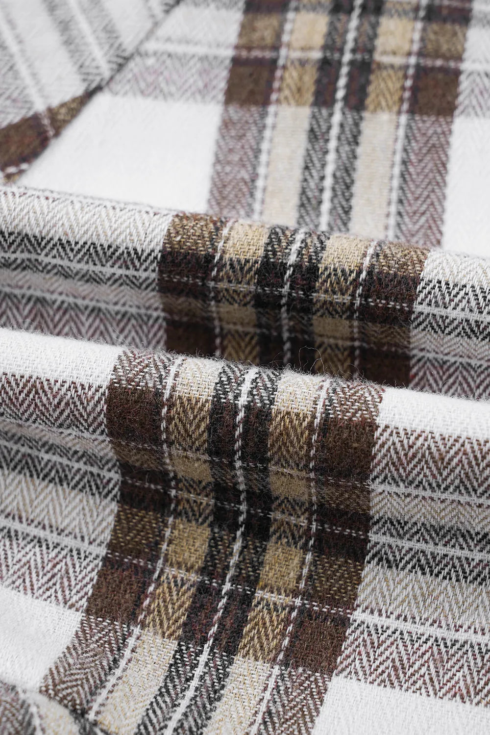 Plaid fabric detail with white, brown, and dark stripes