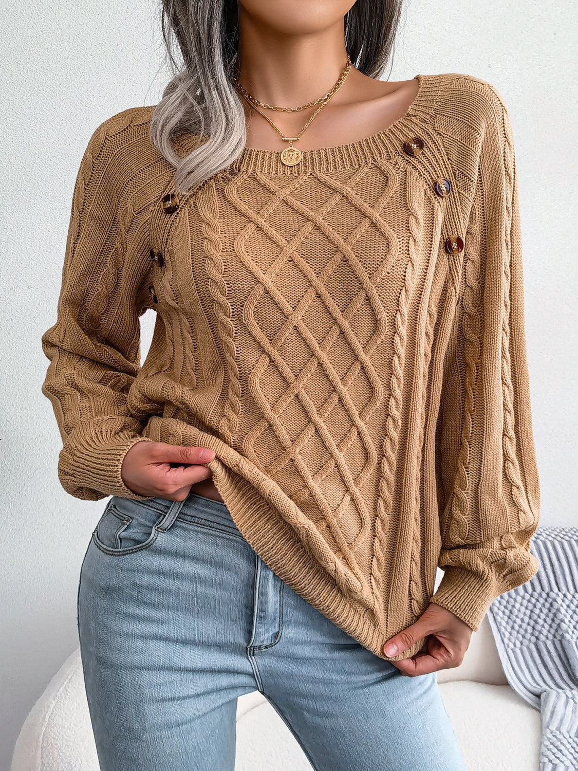 Khaki cable-knit sweater with diamond lattice pattern and decorative button accents
