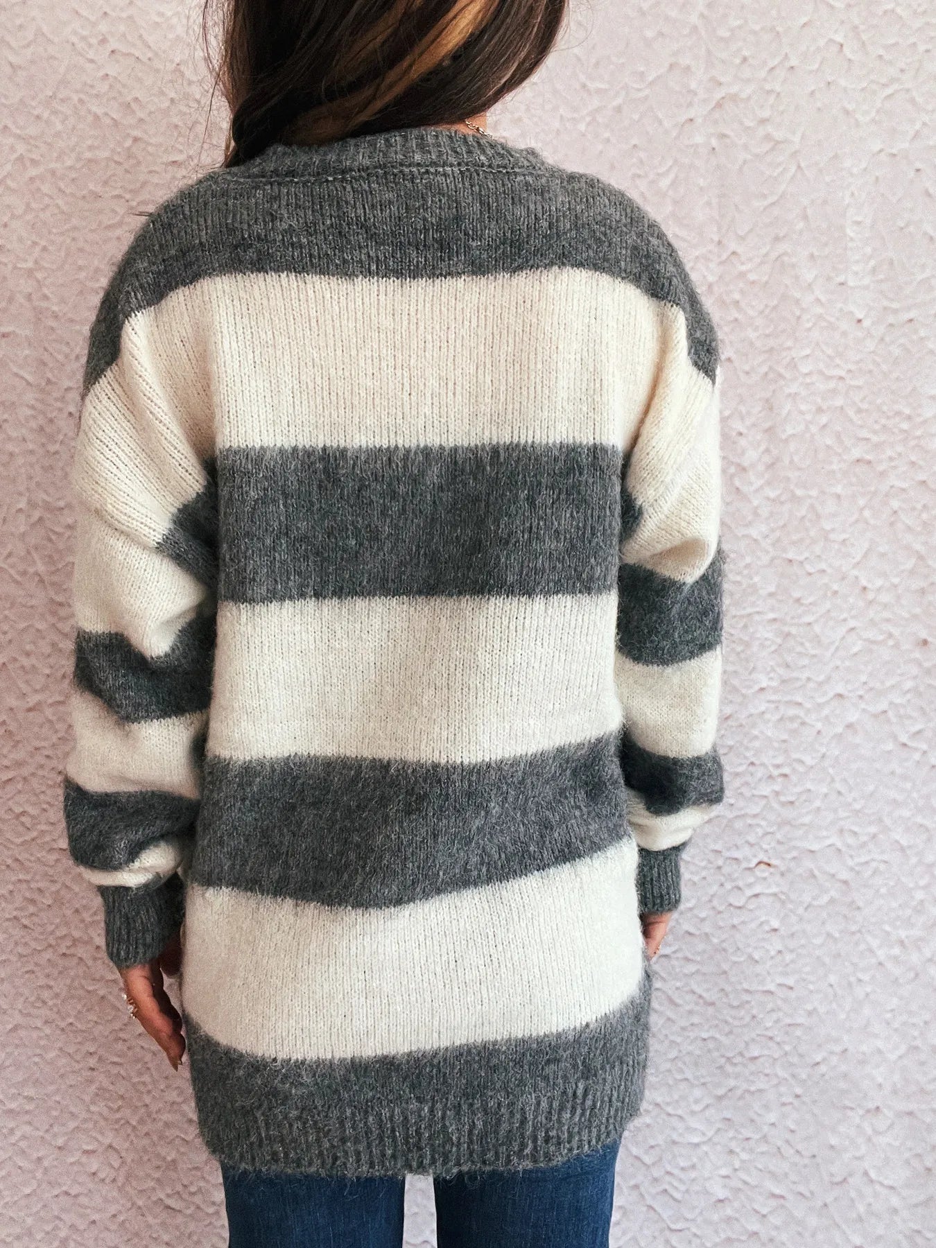 Striped long sleeve sweater, back view with dark gray and white horizontal stripes