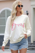White round-neck sweater with pink 'Friend' script graphic, long sleeves