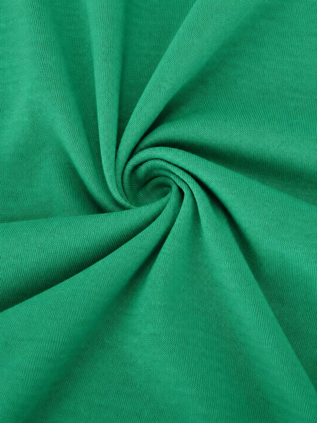 Green knit fabric close-up with soft drape and gathered texture