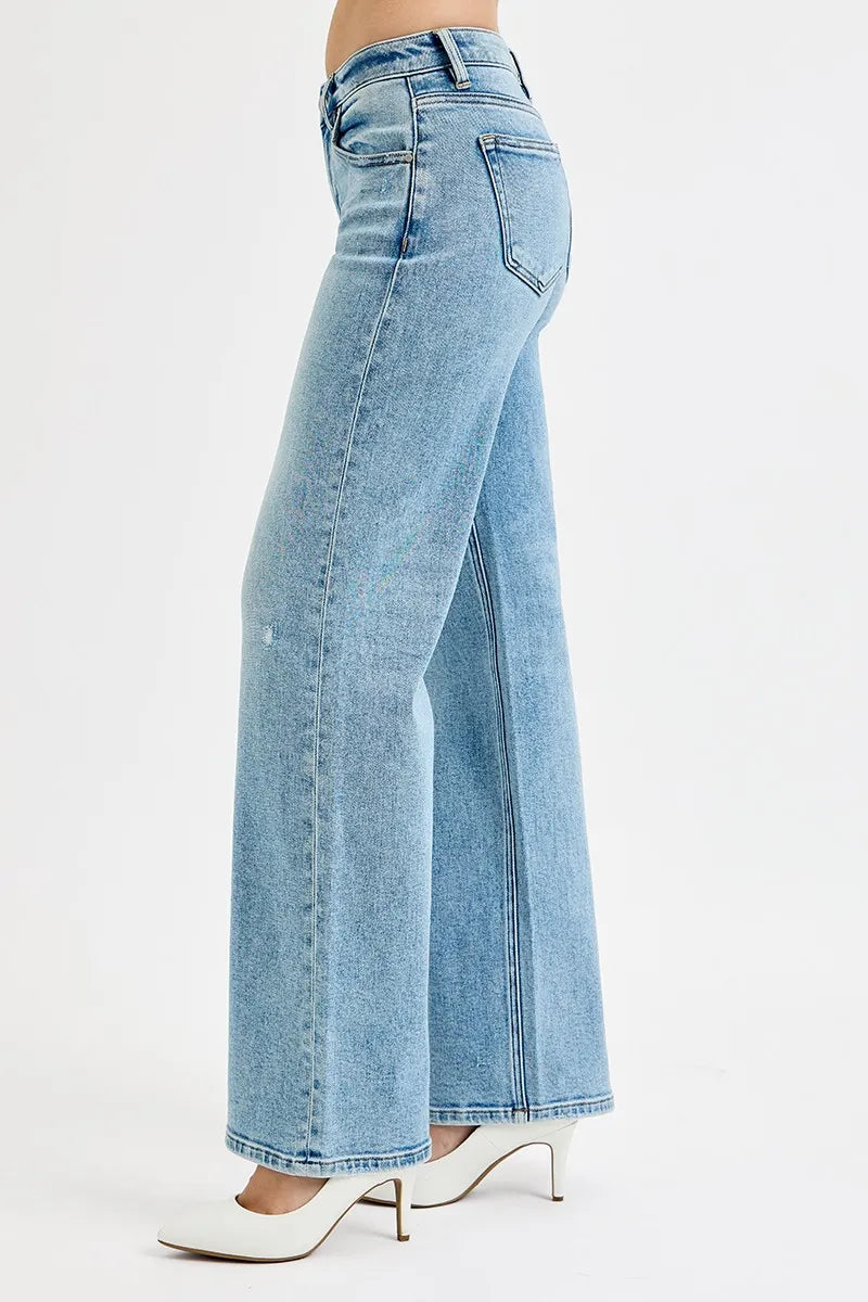 Medium-wash low-rise boyfriend jeans shown from the side, ankle length