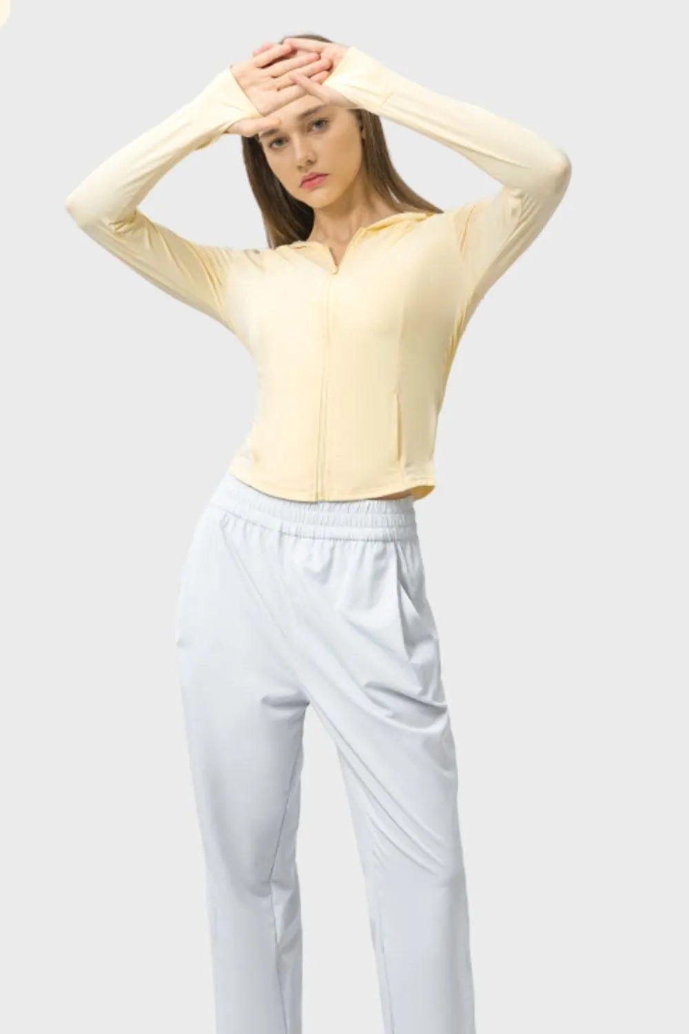 Light yellow zip-up hooded active jacket with long sleeves and hood