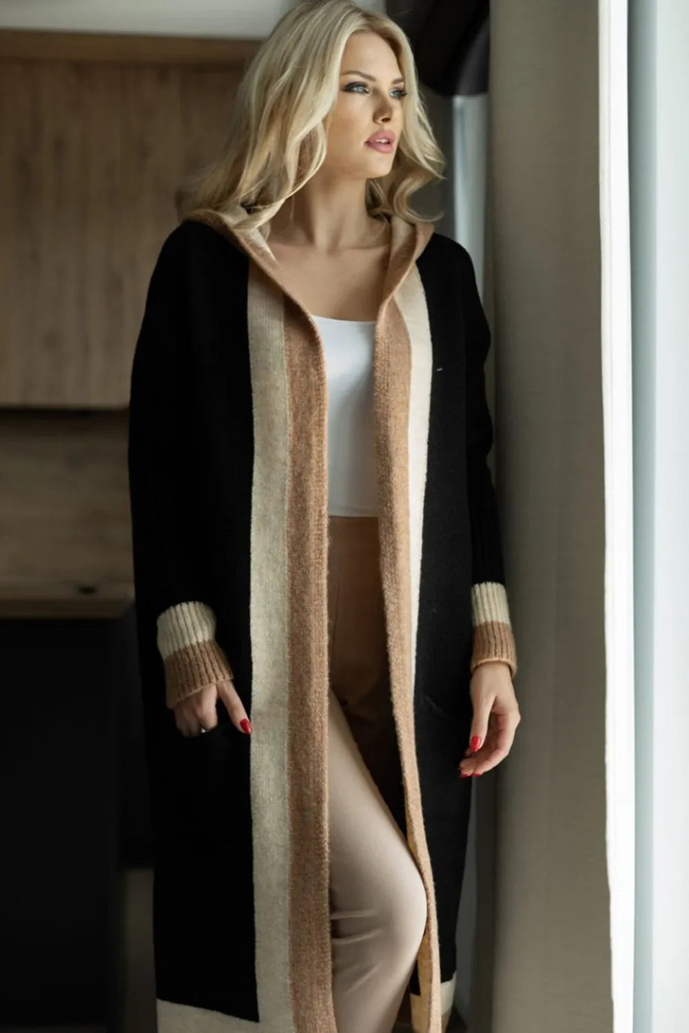 Black hooded long-sleeve cardigan with tan contrast stripe and front pockets